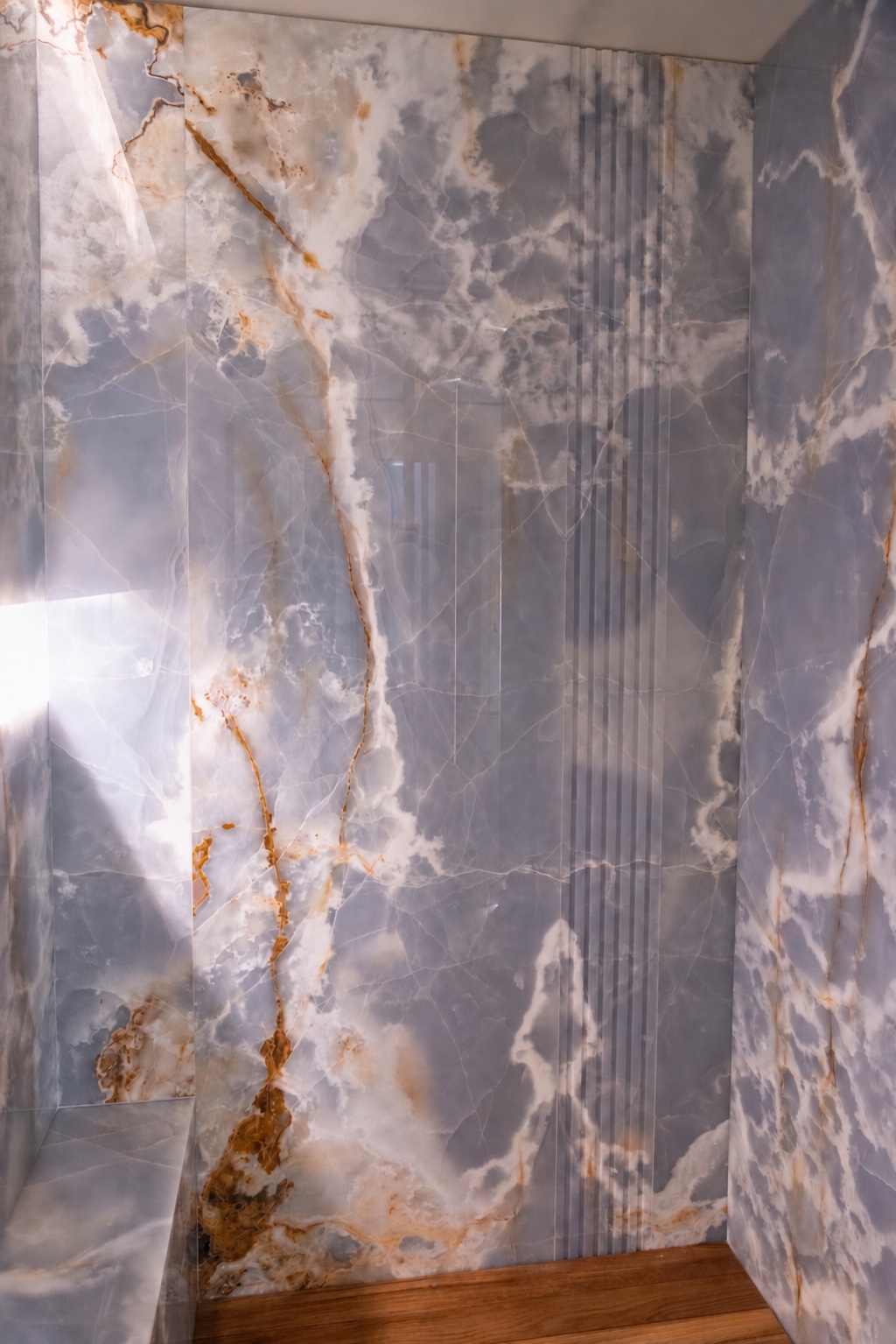 Blue onyx shower wall veined in rust and gold. Open the original photograph full size.