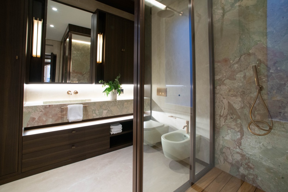 Second bathroom, with a long vanity and tall lights either side of the mirror
